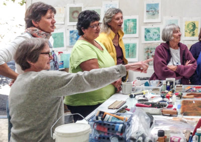 Photo of several artists looking at art in the art studios at O'Hanlon Center.