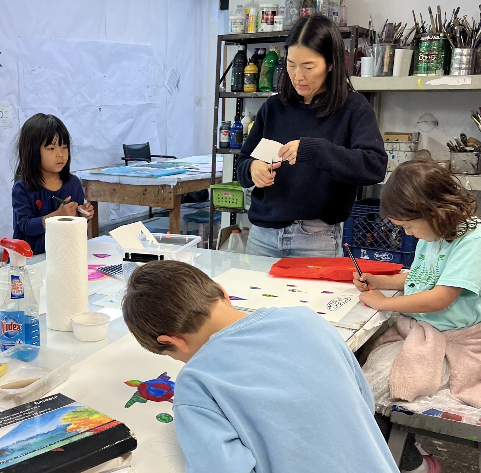 Photo of family members with their artwork on the hillside at O'Hanlon